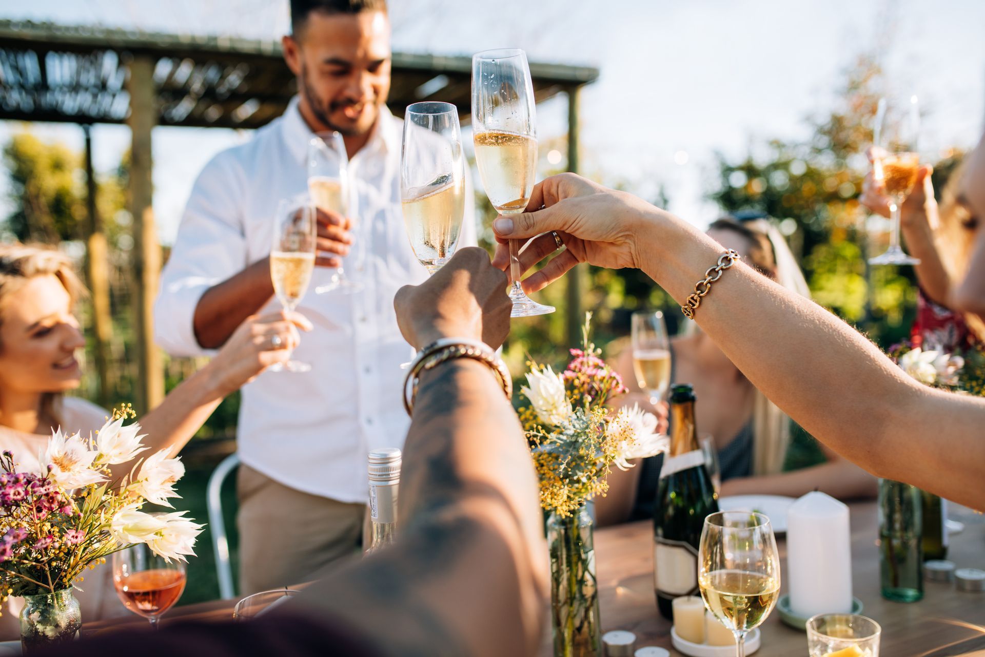 A group of people are toasting with champagne glasses at a table.
