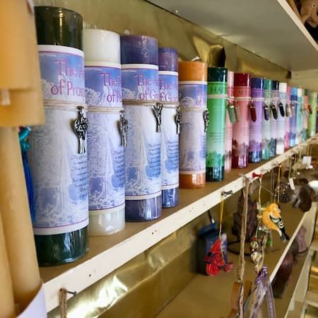 A row of candles are lined up on a shelf