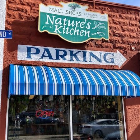 Nature 's kitchen mall shops has a blue and white awning