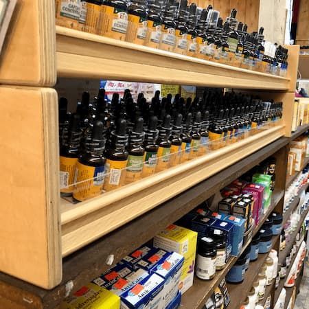 A store shelf filled with lots of bottles and boxes.