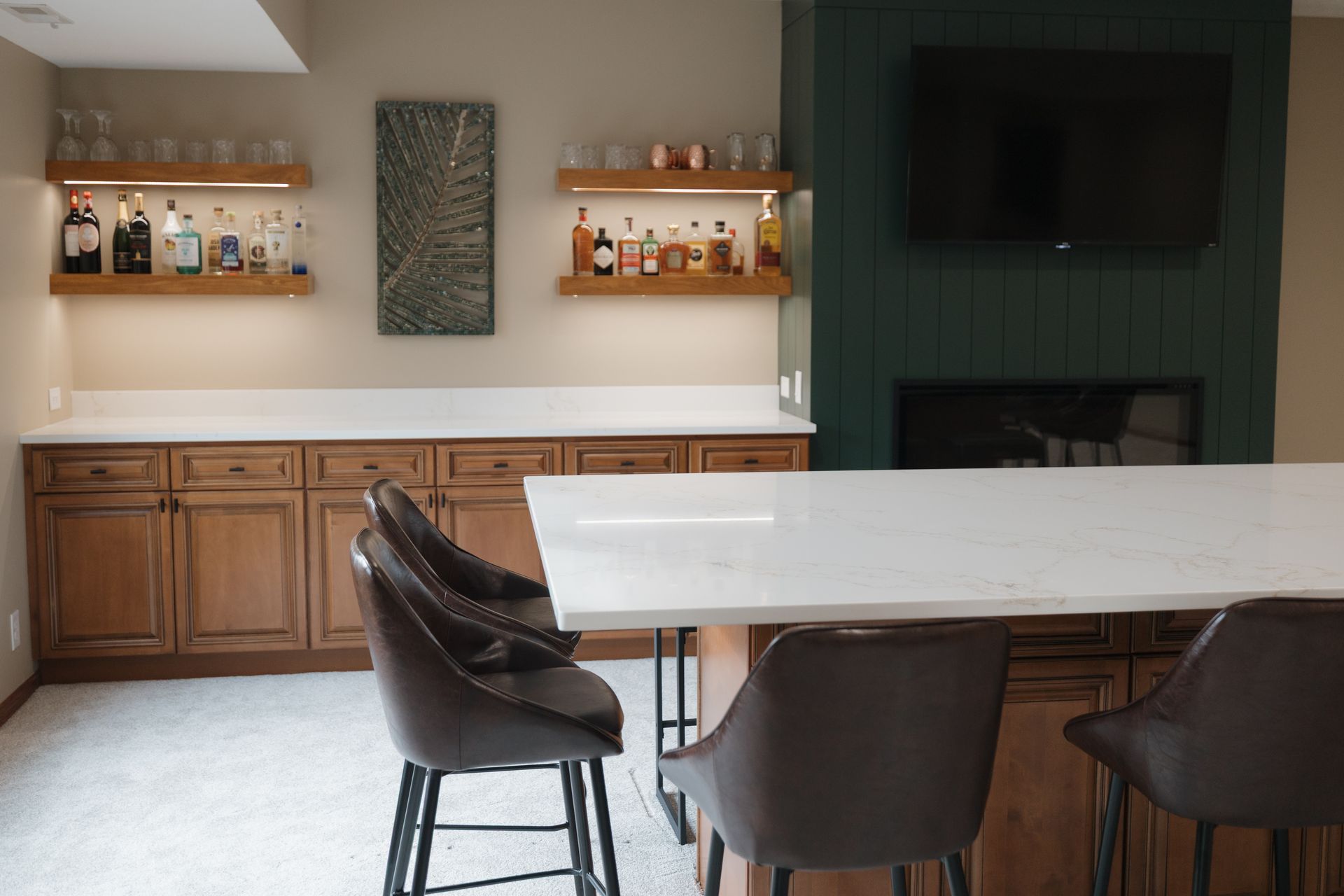 A rustic kitchen with wood cabinets, a granite-topped island, and a vaulted ceiling with hanging pendant lights.