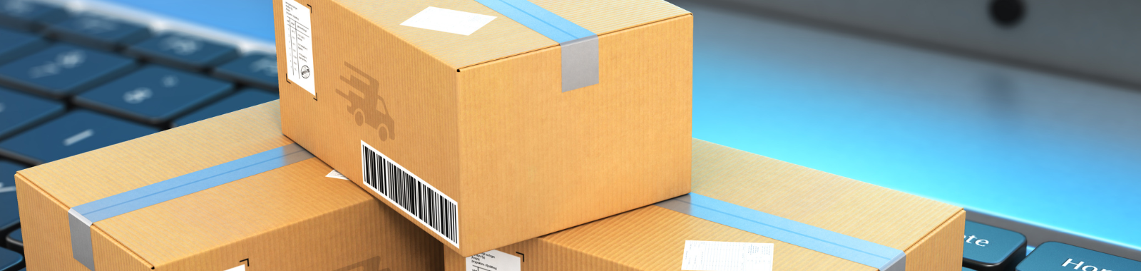 Three cardboard boxes are stacked on top of each other on a laptop keyboard.