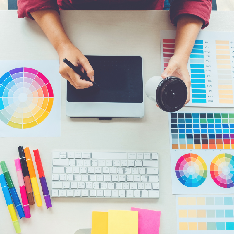 A person is sitting at a desk using a graphic tablet.