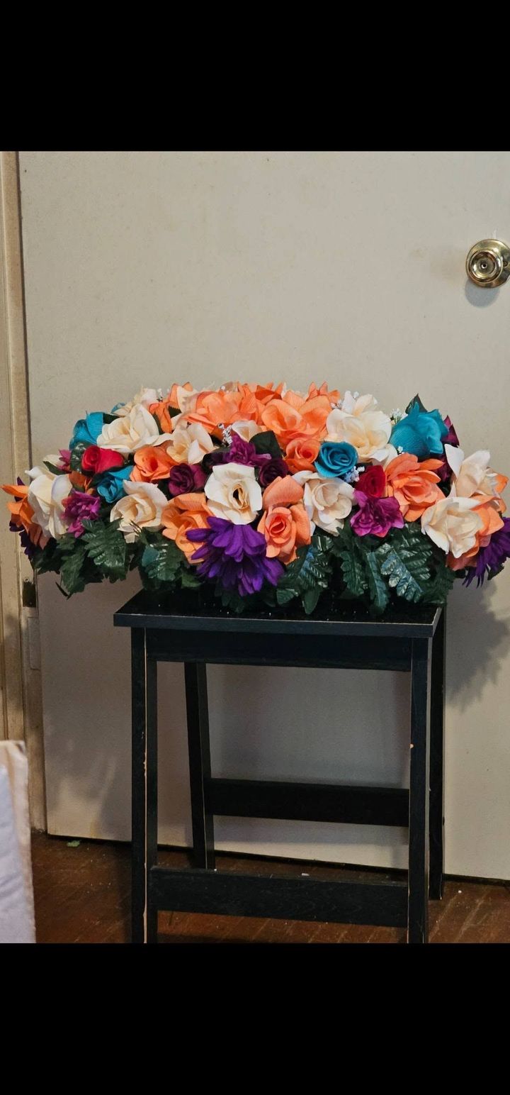 A bunch of flowers are sitting on a table in front of a door.