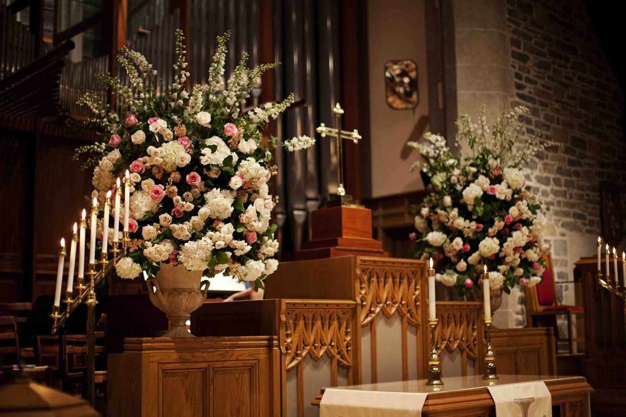 A church with flowers and candles on the altar