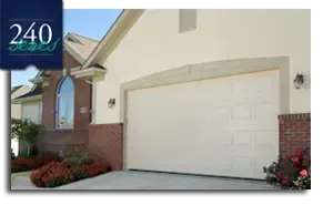 A picture of a house with a white garage door