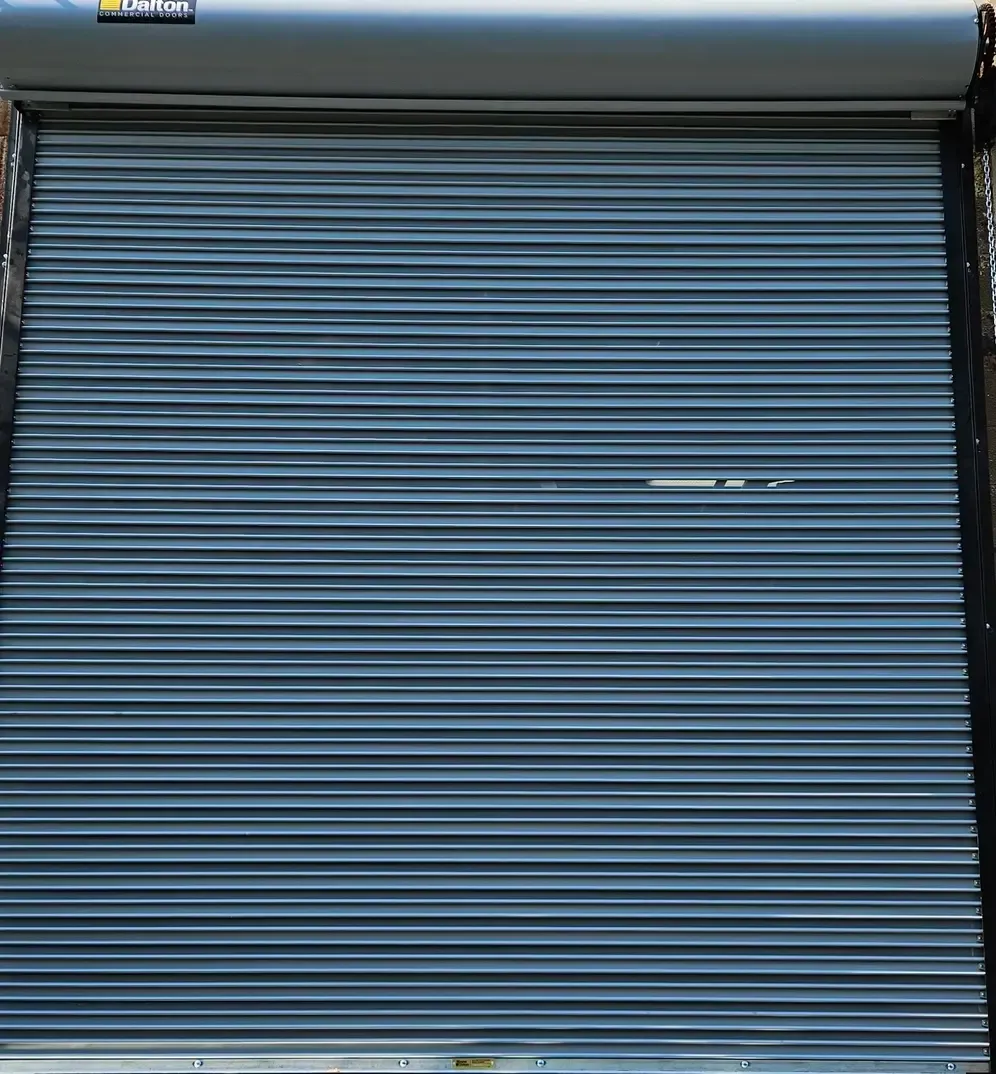 A close up of a blue garage door with a sticker on it.