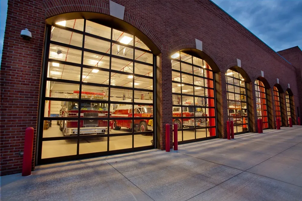 A fire truck is parked in the garage of a fire station