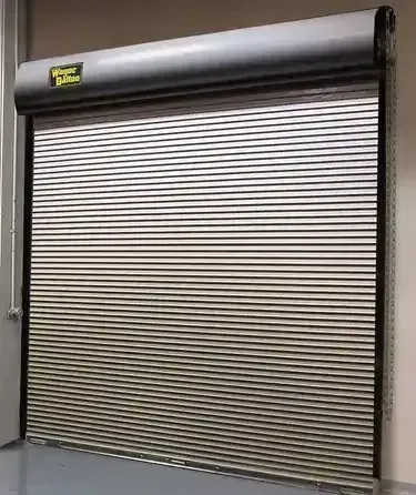 A stainless steel garage door is open in a room.