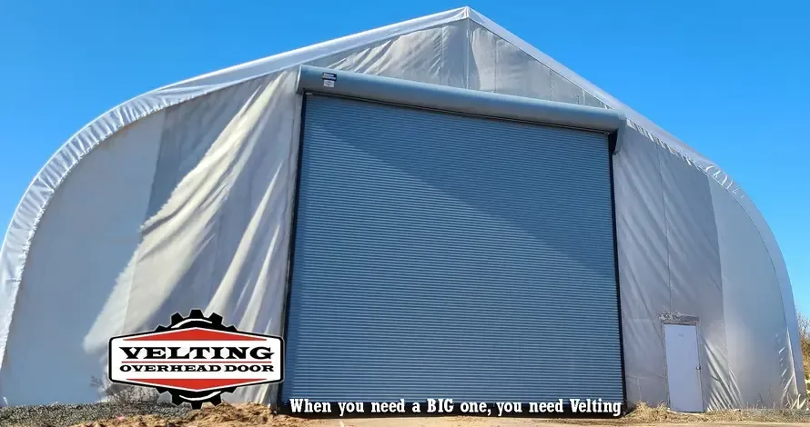 A large white tent with a large garage door