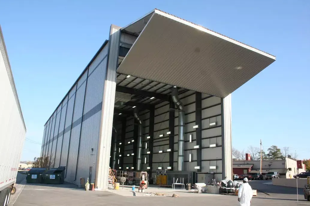 A large building with a large roof is being built