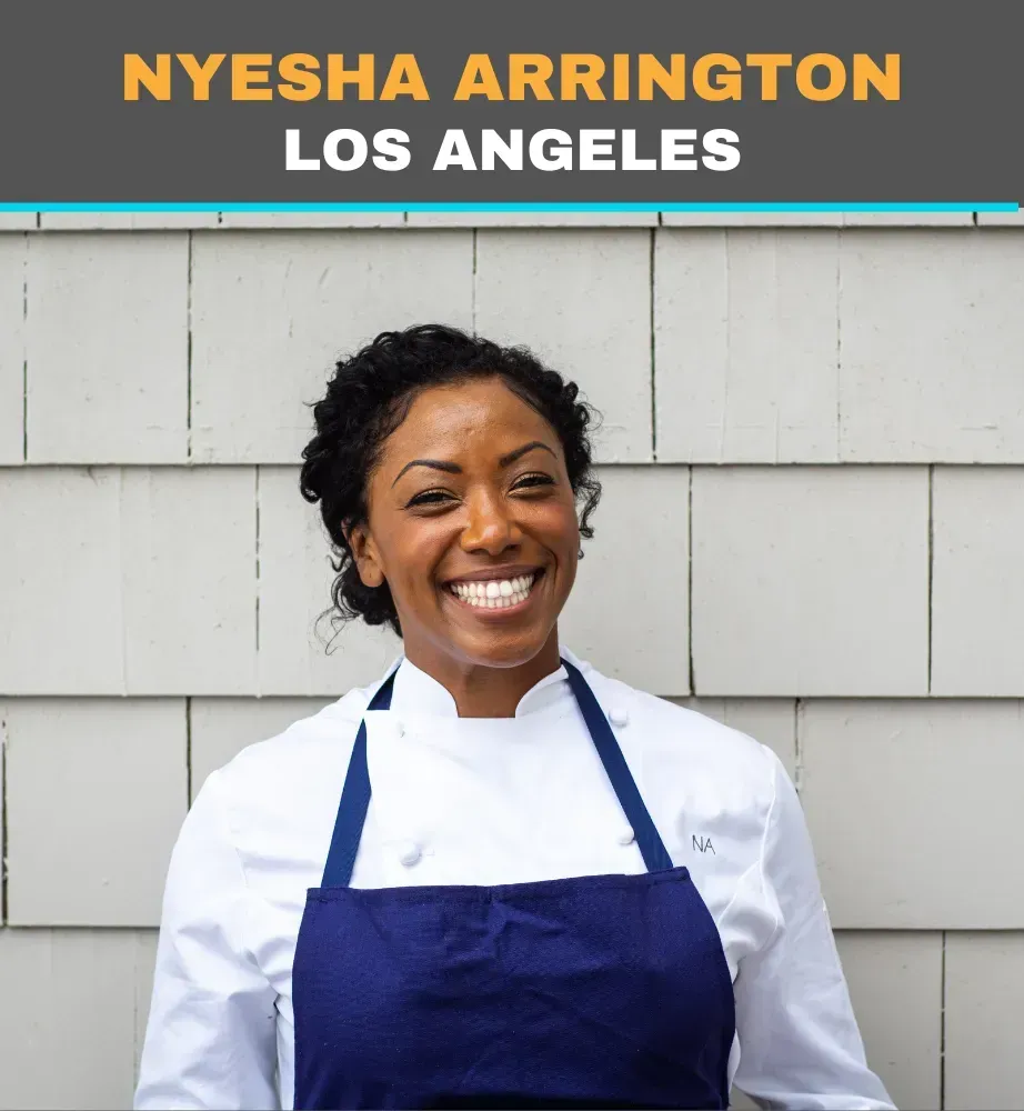 Smiling chef in white coat and blue apron with “Nyesha Arrington, Los Angeles” text above