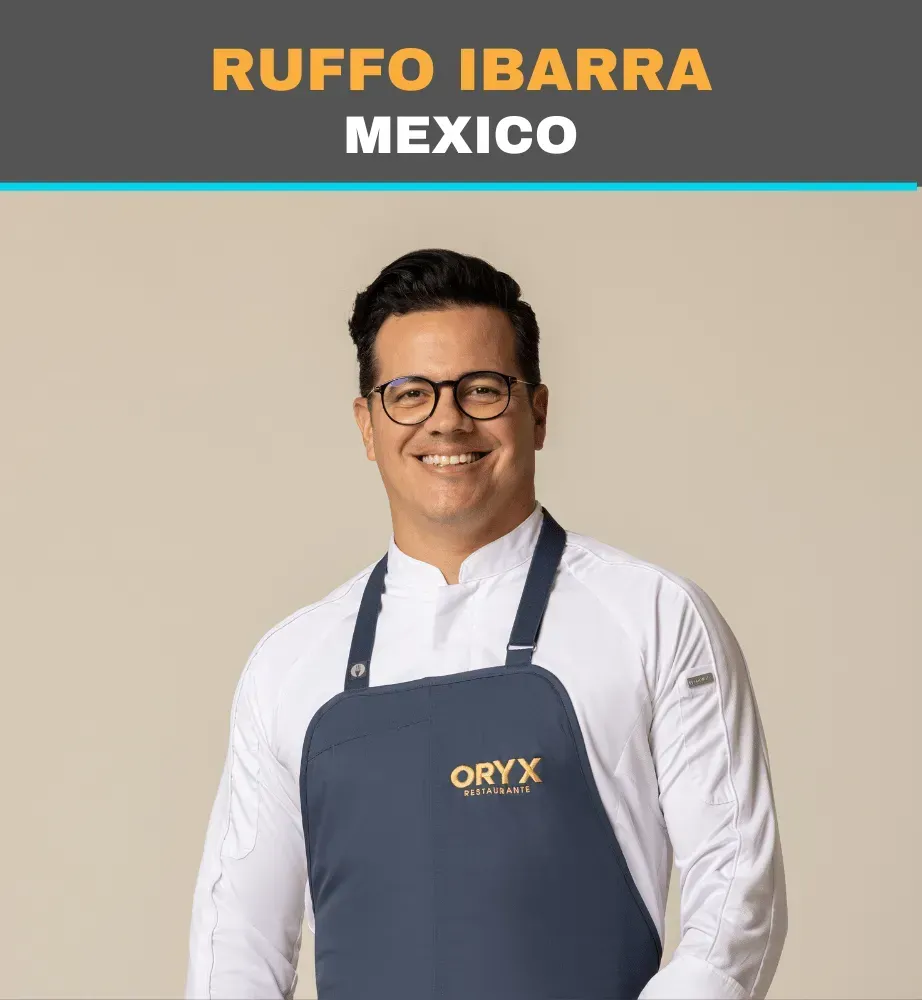 Ruffo Ibarra of Mexico smiling in a white shirt and navy apron against a beige background