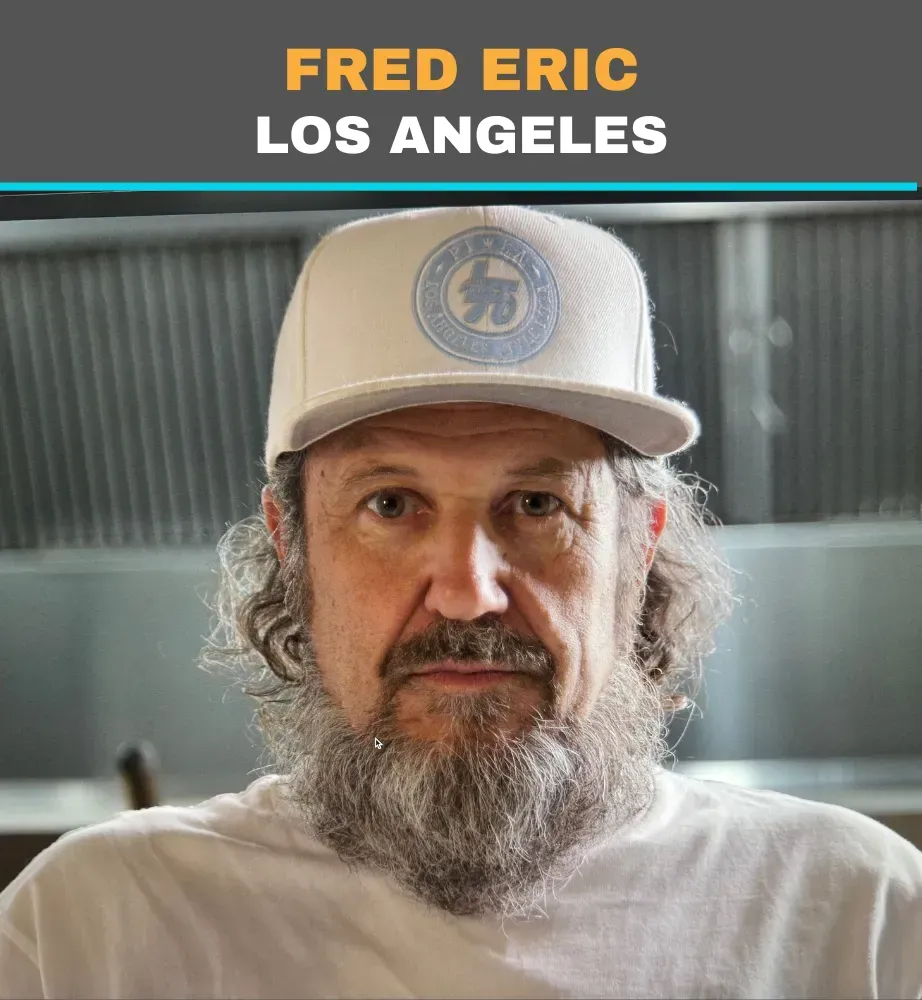 Portrait of a bearded man in a white cap and shirt, with “FRED ERIC LOS ANGELES” text above.