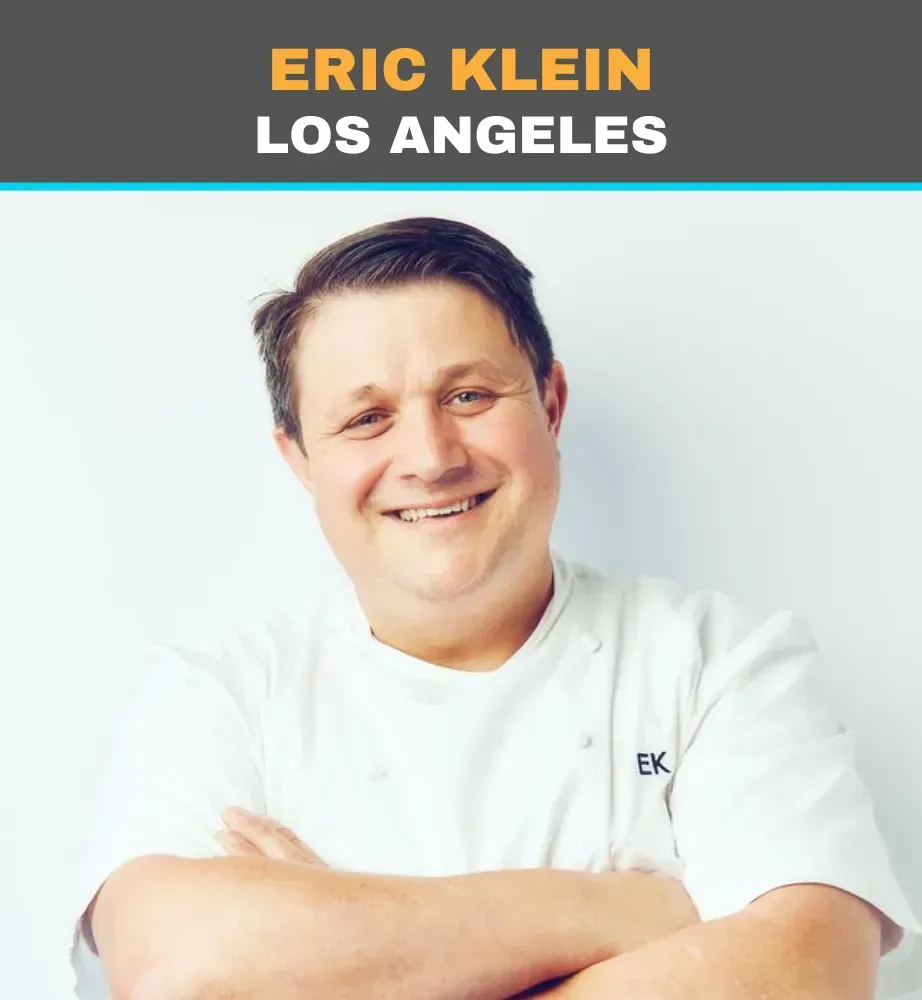 Portrait of Eric Klein in a white shirt, smiling with arms crossed, labeled “Los Angeles” at the top