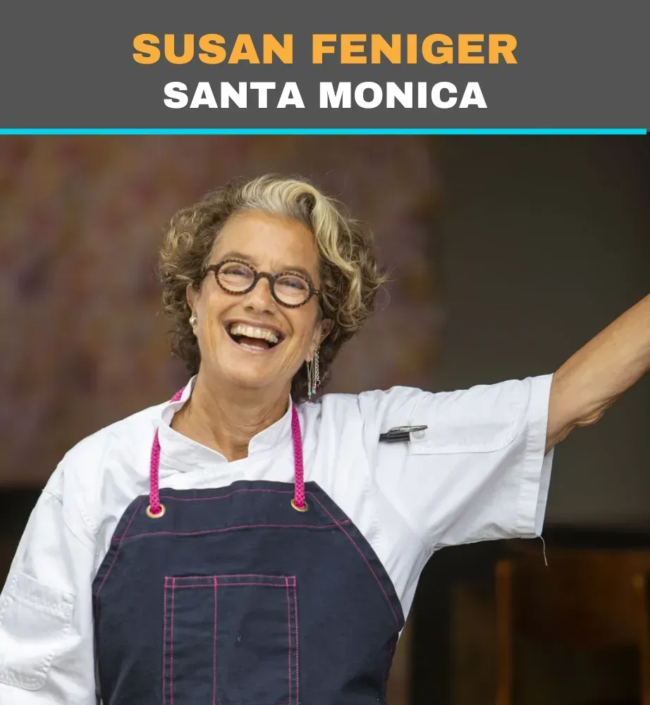 Susan Feniger smiling in a navy apron and white shirt, with “Santa Monica” text above.