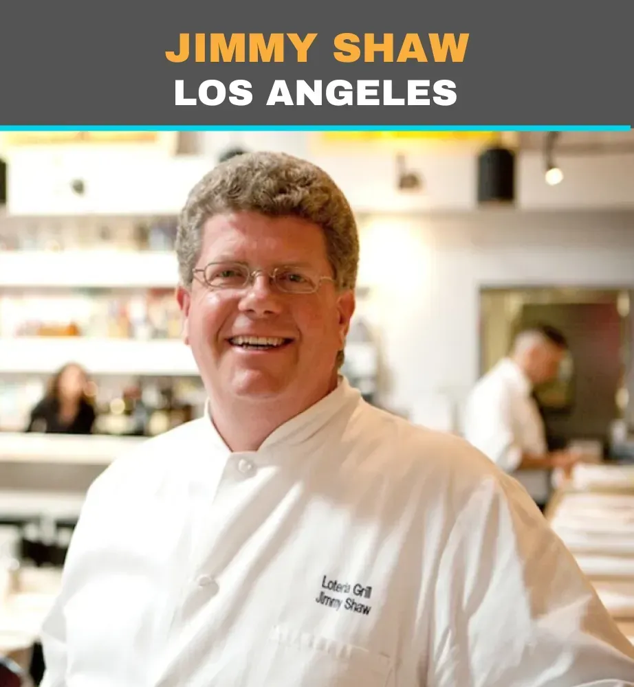 Chef Jimmy Shaw smiling in a white coat at a Los Angeles restaurant.