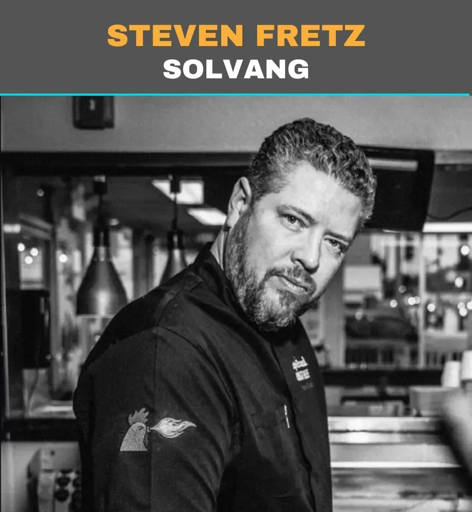 Portrait of Steven Fretz Solvang in a black shirt at a restaurant or bar setting