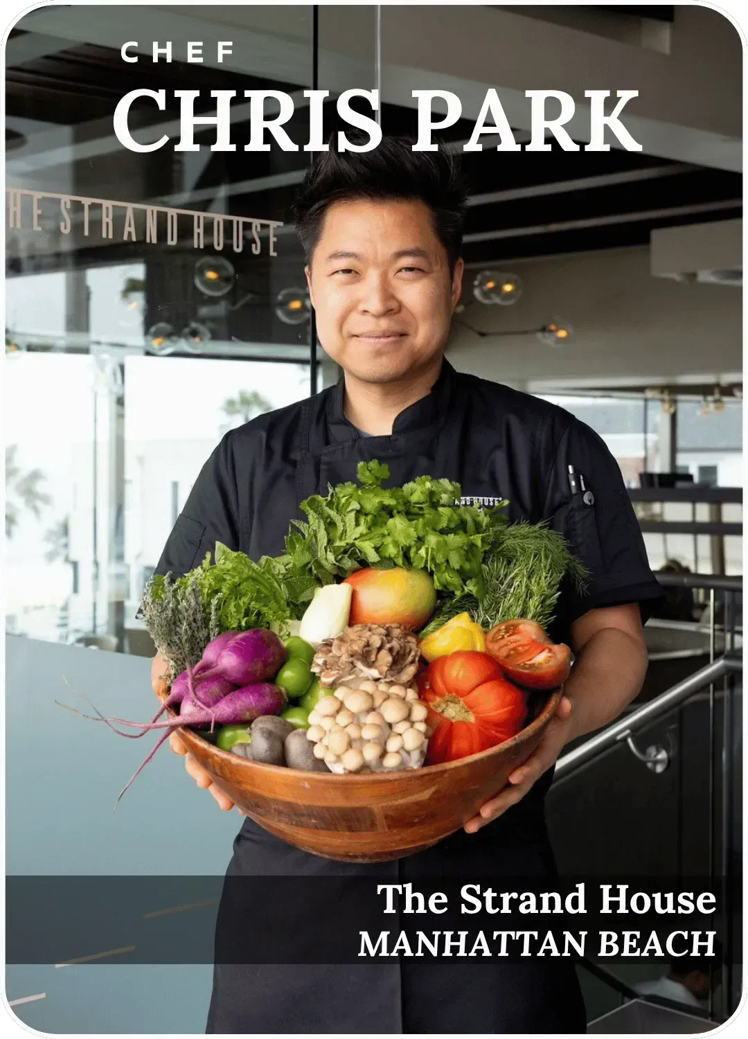 Chef Chris Park holding a basket of vegetables at The Strand House, Manhattan Beach