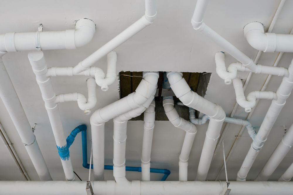 A Bunch of White Pipes Are Hanging From the Ceiling — MacKenzie Plumbing In West Mackay, QLD