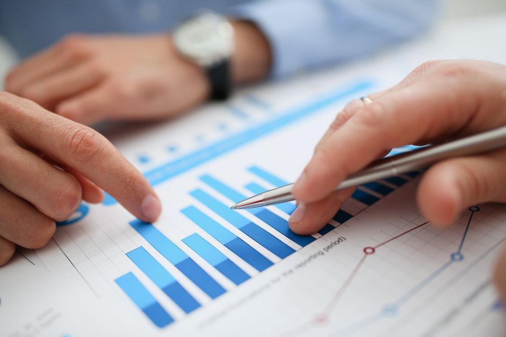 Two People Analysing a Bar Graph, One Pointing at It With a Finger, the Other Holding a Pen — Accountsloop Tax & Business Advisory in Geelong, VIC