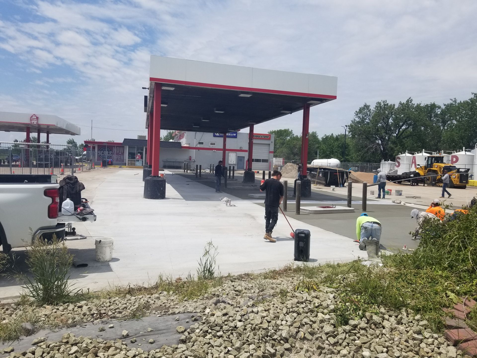 A concrete floor in a garage with a wooden wall.