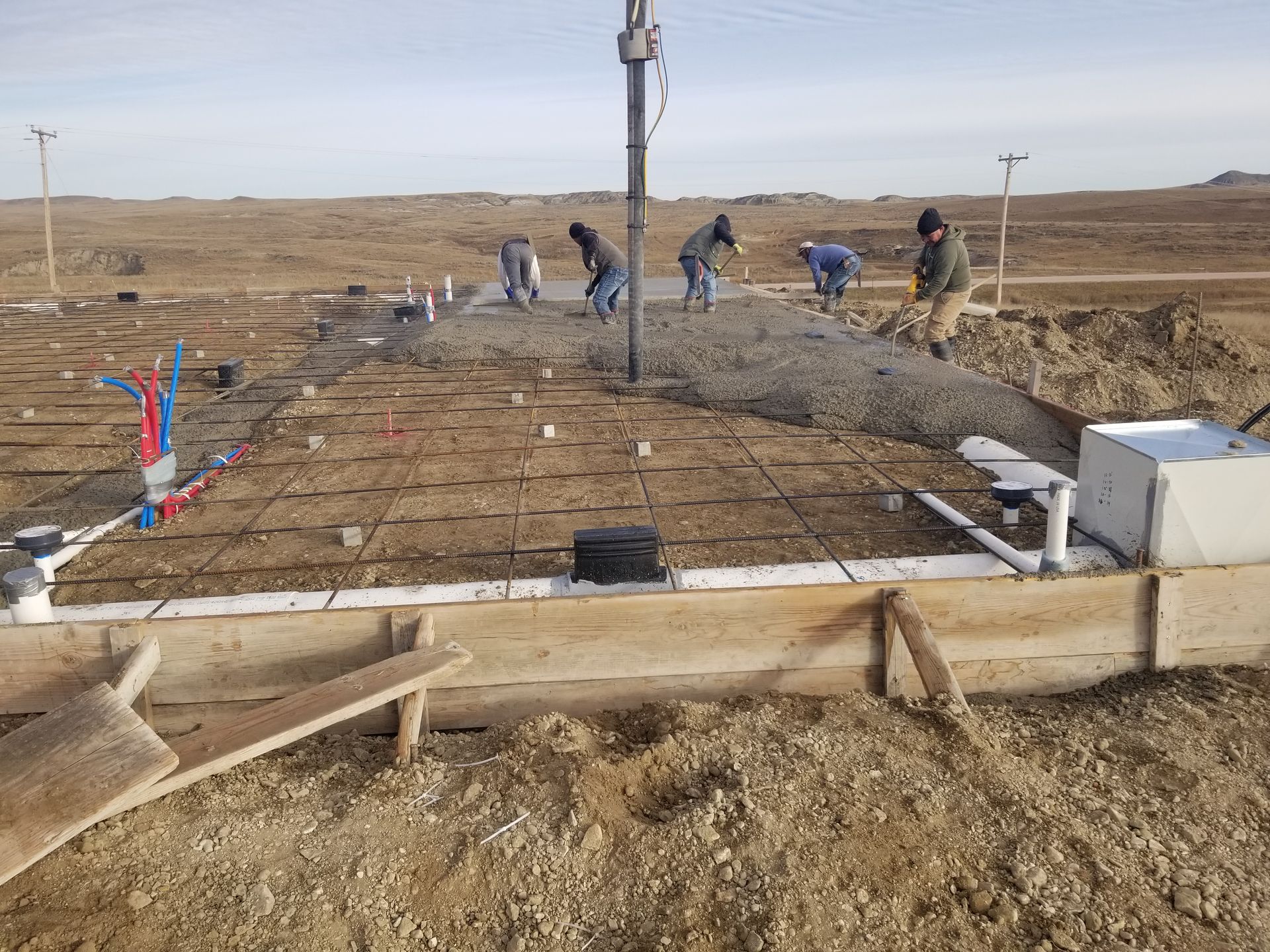 A concrete floor in a garage with a wooden wall.