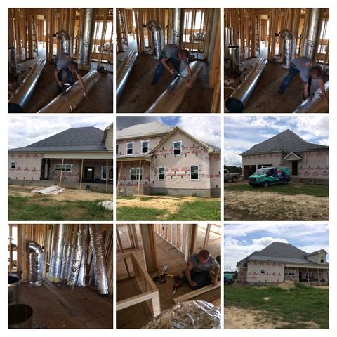 Construction of a house with visible framing, ductwork, and workers installing HVAC systems.