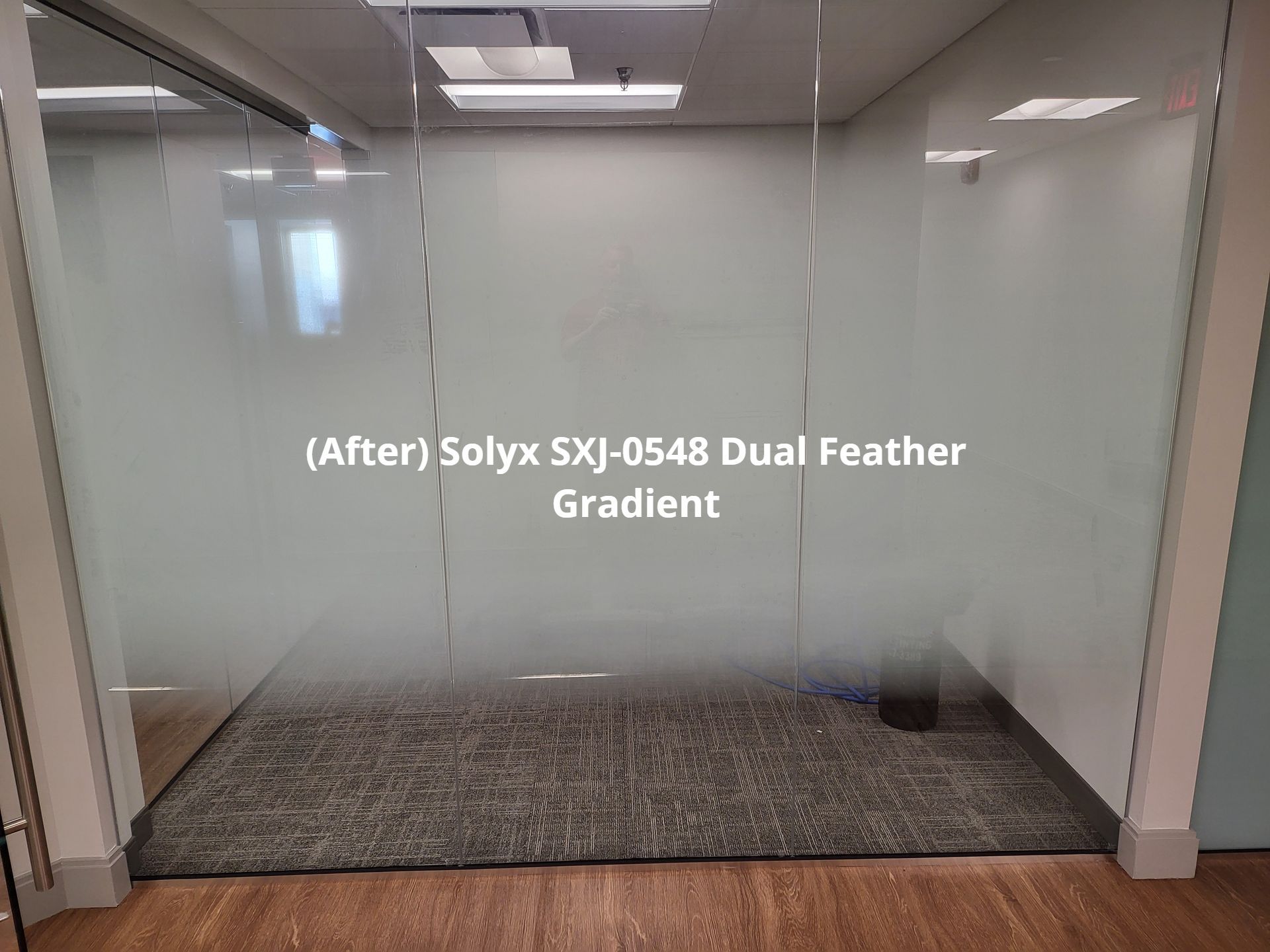 A room with a glass wall and a sign that says after solyx sxj-0548 dual feather gradient
