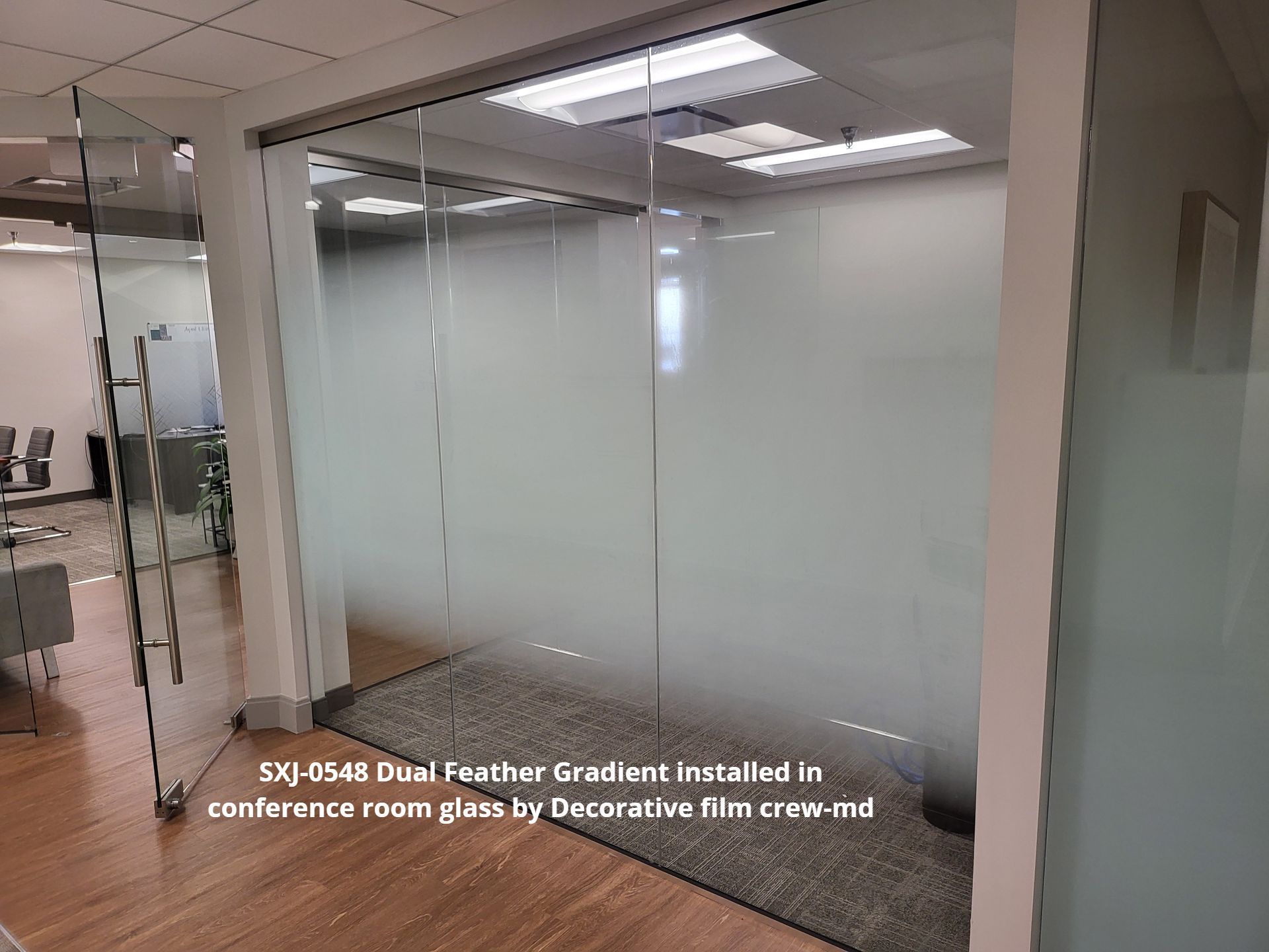 A room with a glass wall and a sliding glass door.