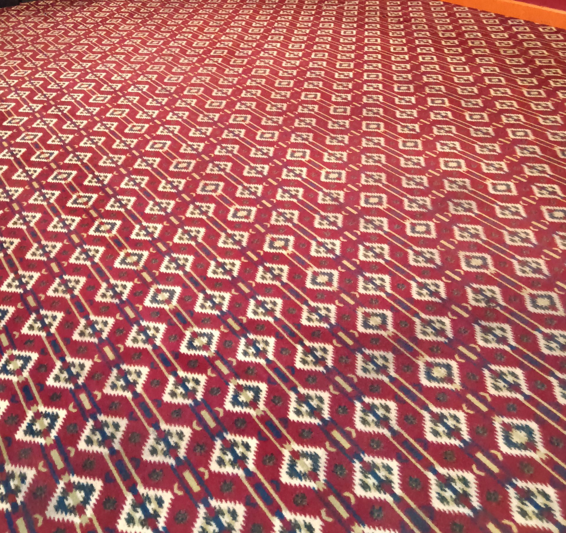A red carpet with a blue and white pattern on it