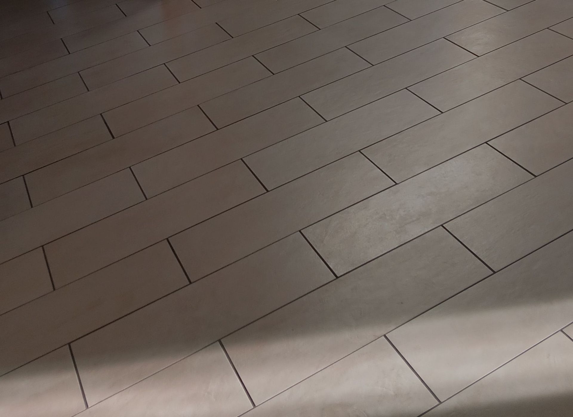 A close up of a tiled floor with a diagonal pattern