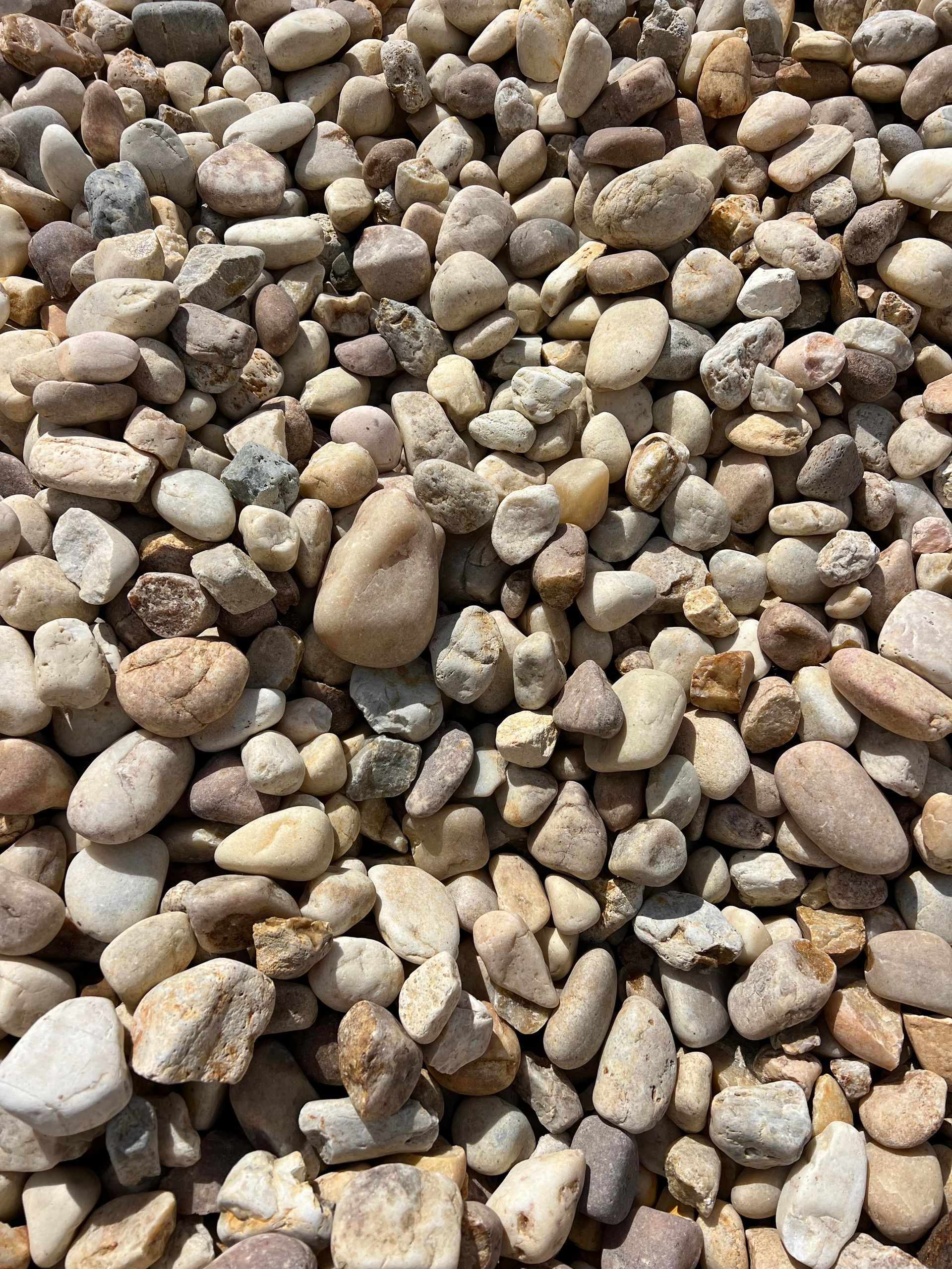 A pile of rocks is sitting on the ground.