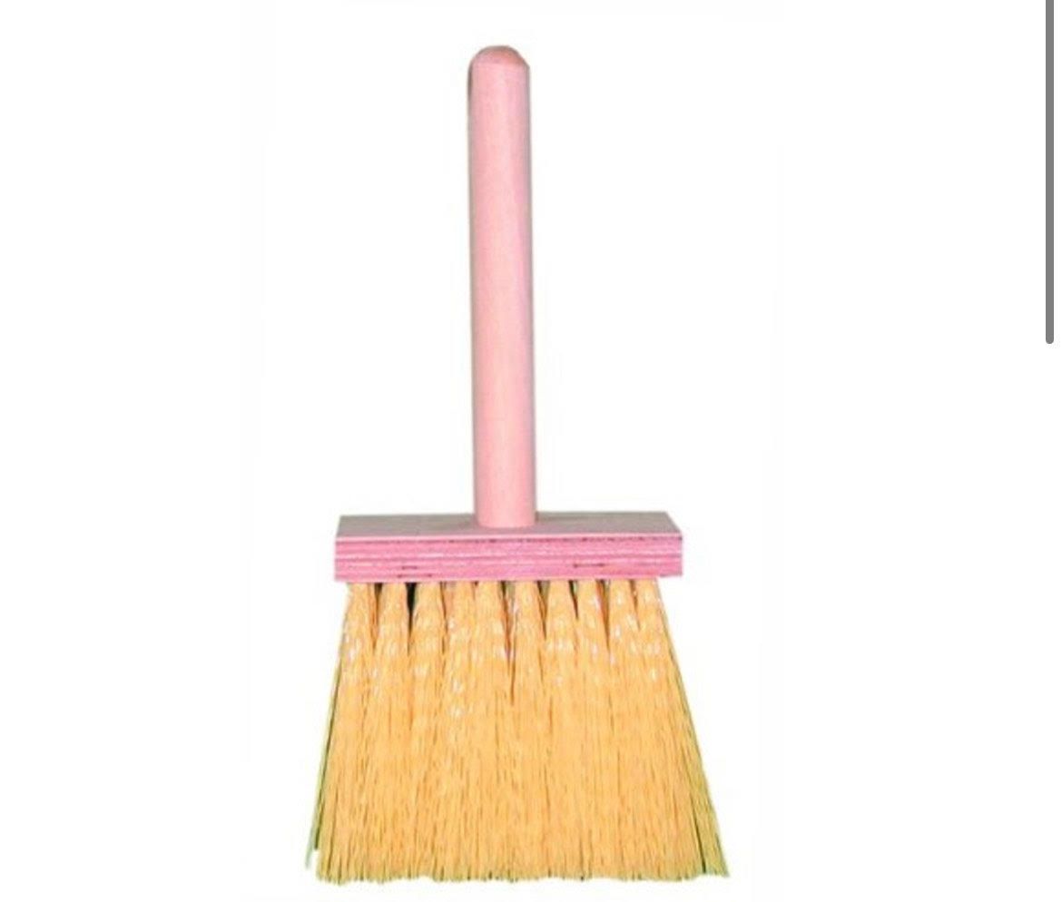A small broom with a pink handle and bristles