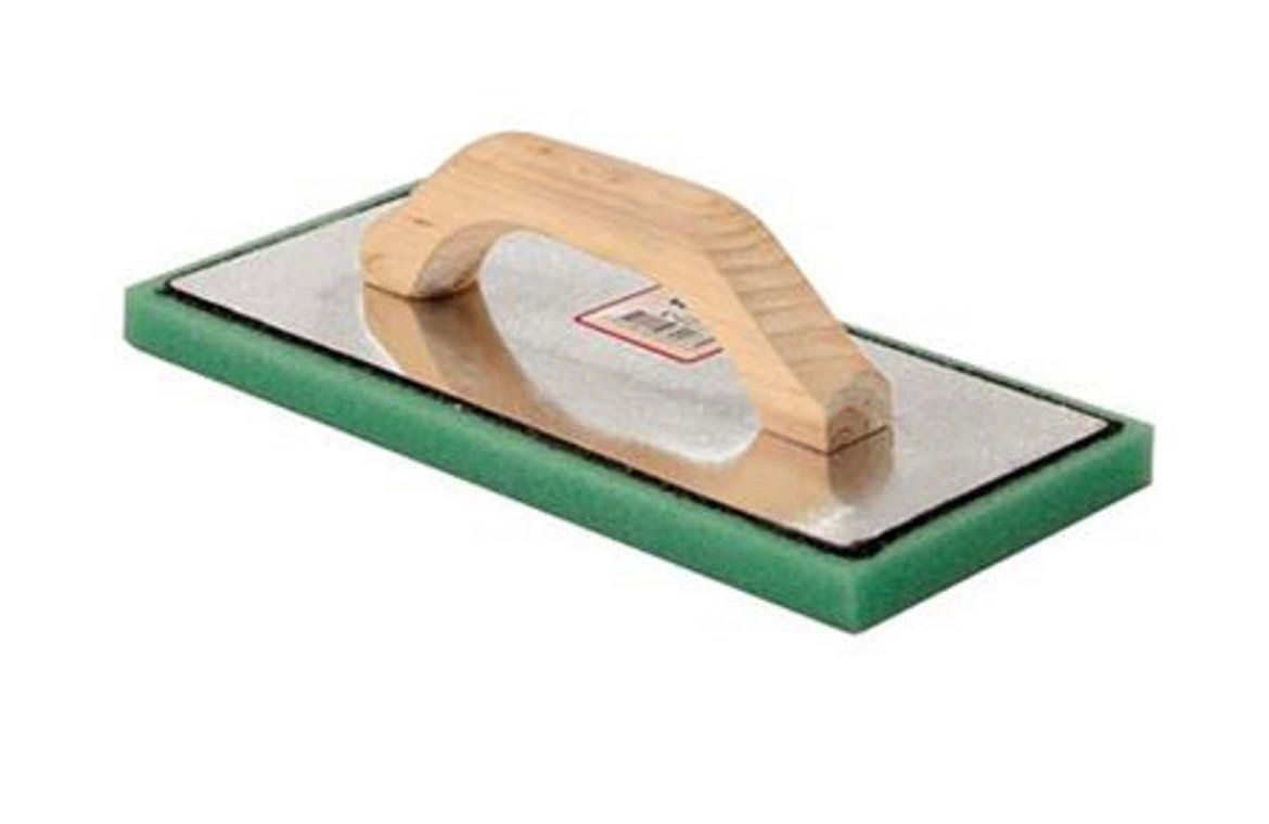 A green sponge with a wooden handle on a white background