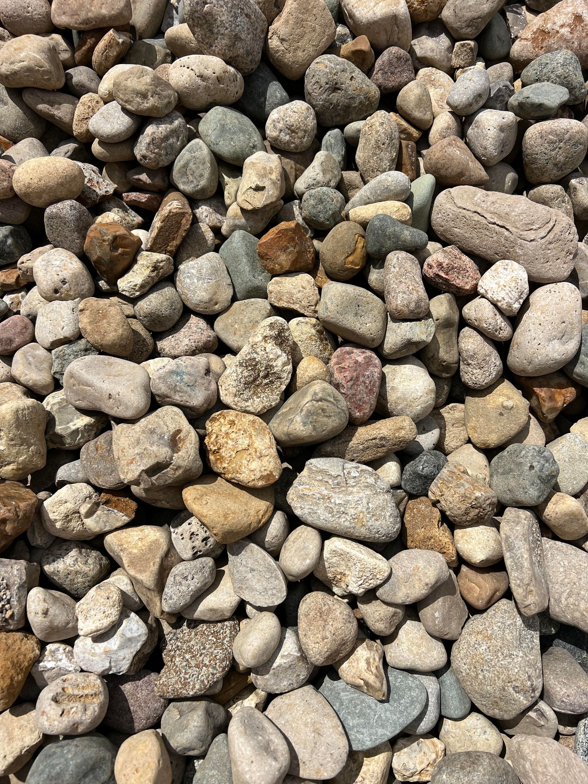 A pile of rocks of different sizes and colors.