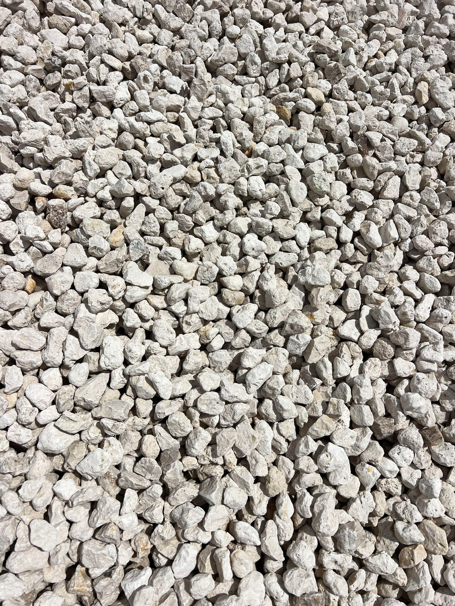 A pile of white gravel is sitting on the ground.