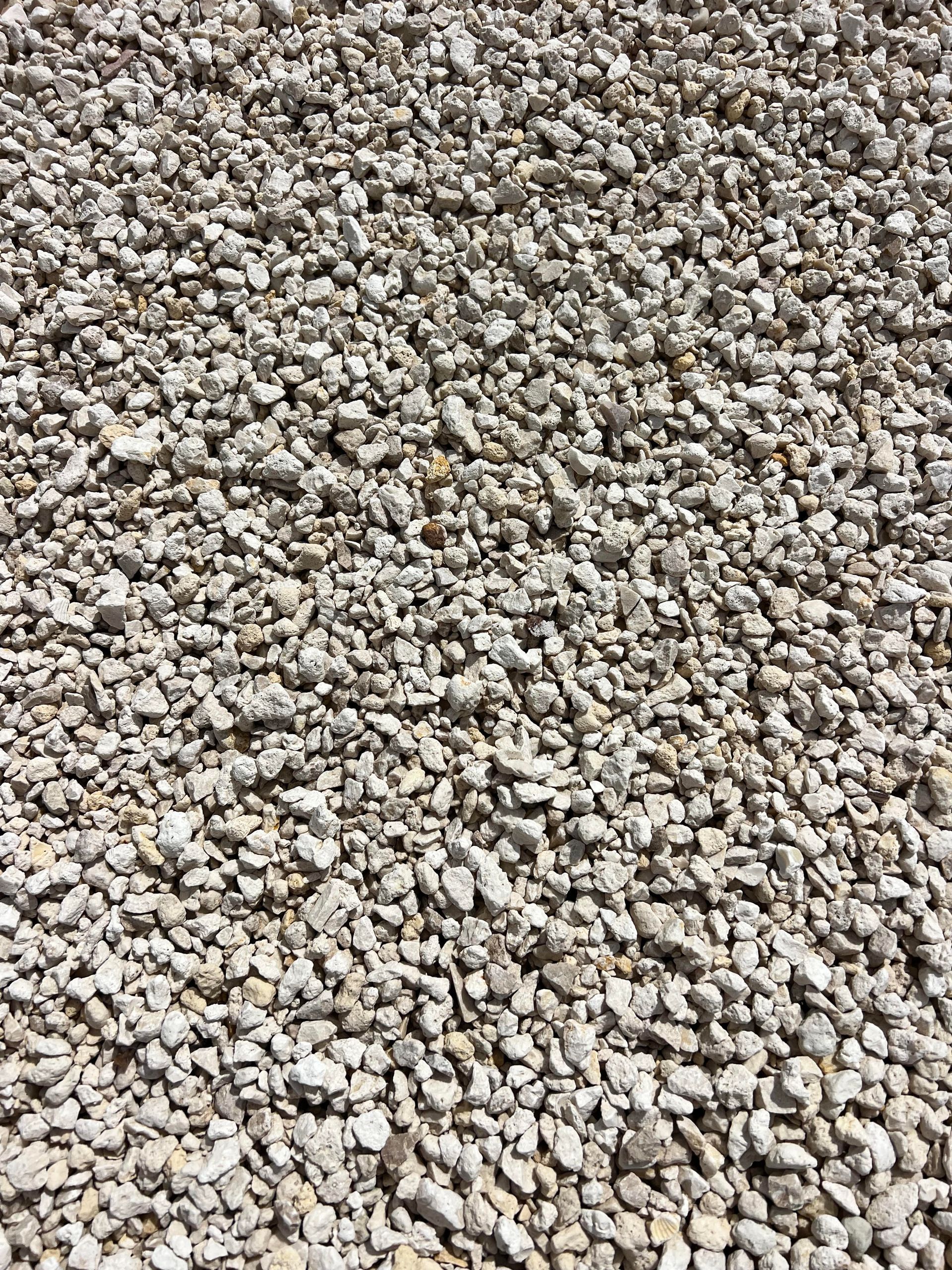 A pile of gravel is sitting on the ground.