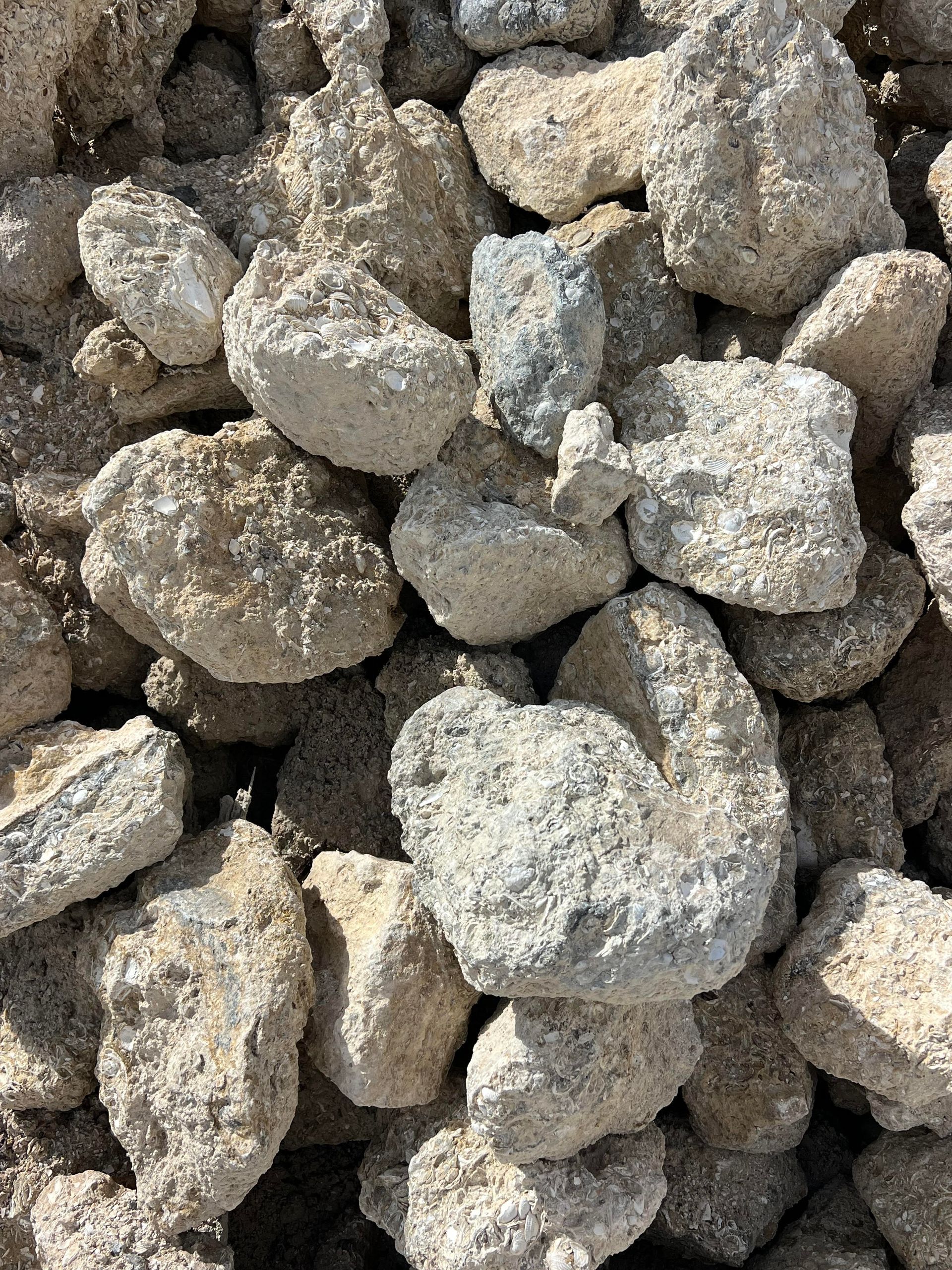 A pile of rocks sitting on top of each other on the ground.