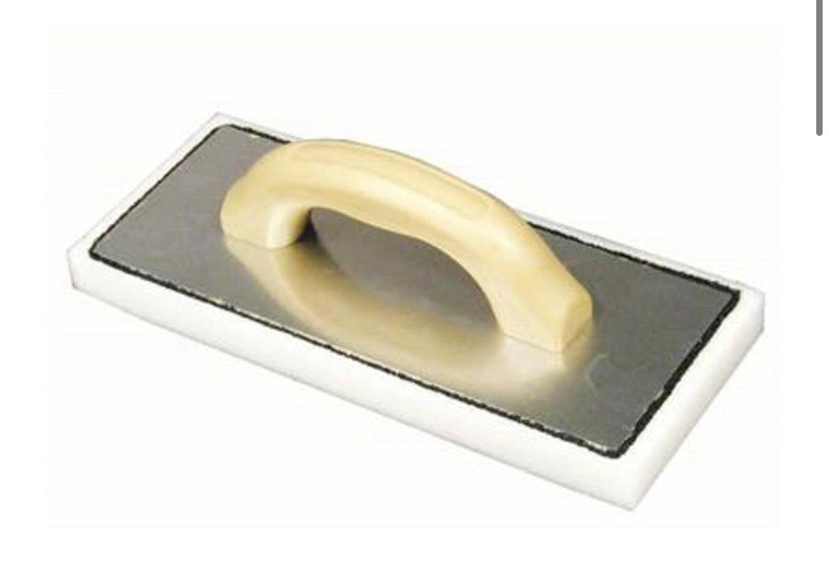 A white sponge with a wooden handle on a white background