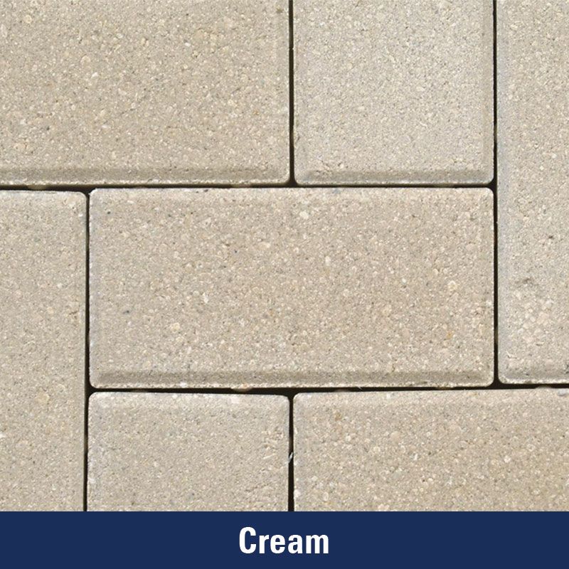 A close up of a cream colored brick wall