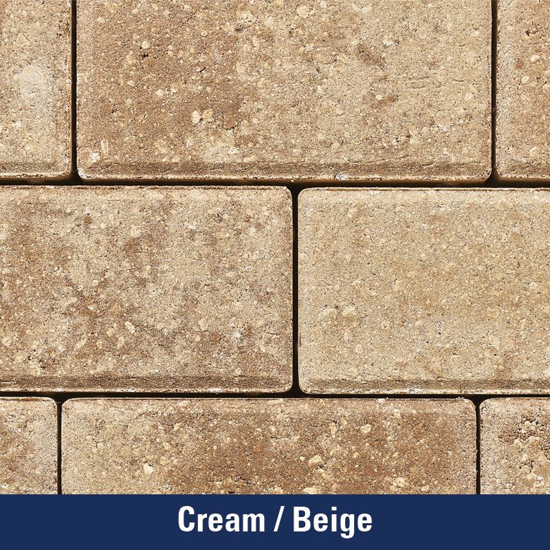 A close up of a cream beige brick wall