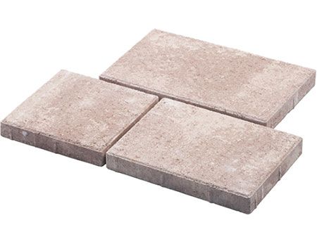 Three bricks are stacked on top of each other on a white surface.