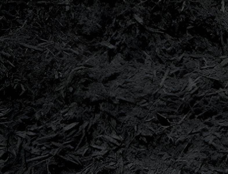 A close up of a pile of black mulch.