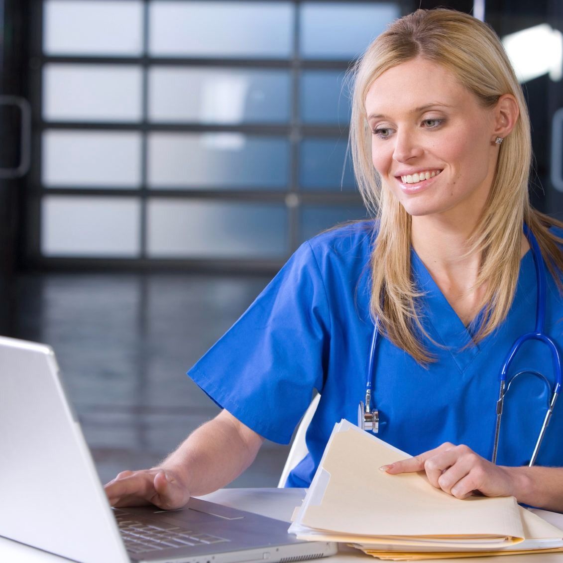 Female nurse at a desk working in a modern office