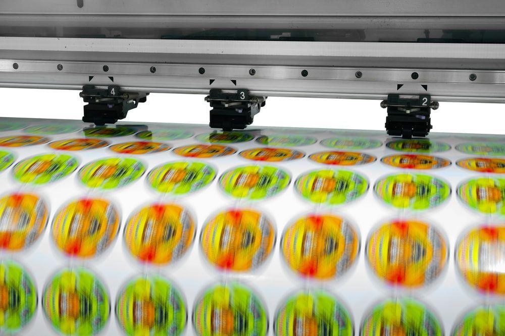 A Machine Is Printing Stickers on A Sheet of Paper — Illawarra Sign Group in Cronulla, NSW
