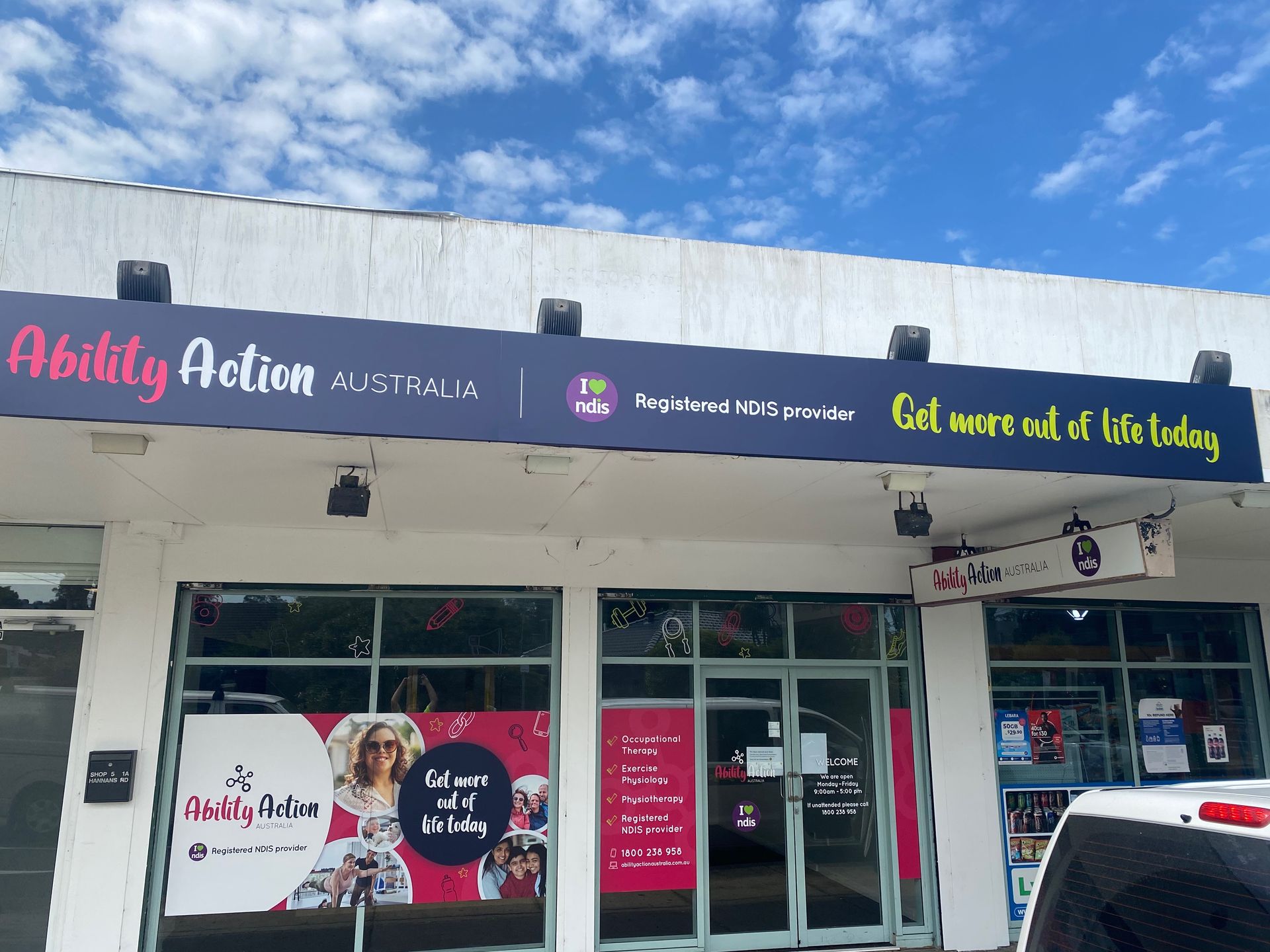 A White Building with A Sign that Says Ability Action — Illawarra Sign Group in Bulli, NSW