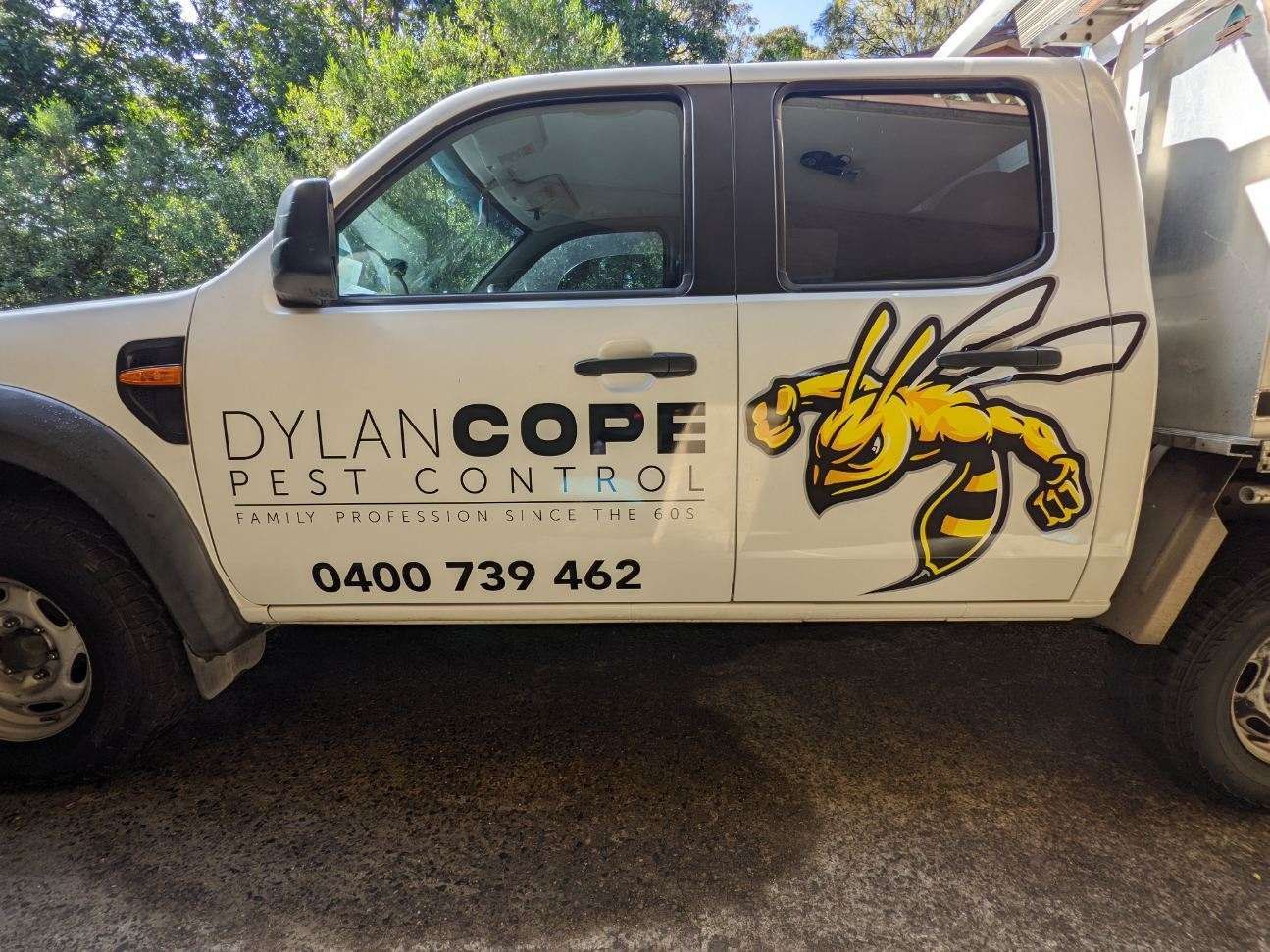 A White Truck with A Bee on The Side Is Parked on The Side of The Road — Illawarra Sign Group in Bulli, NSW
