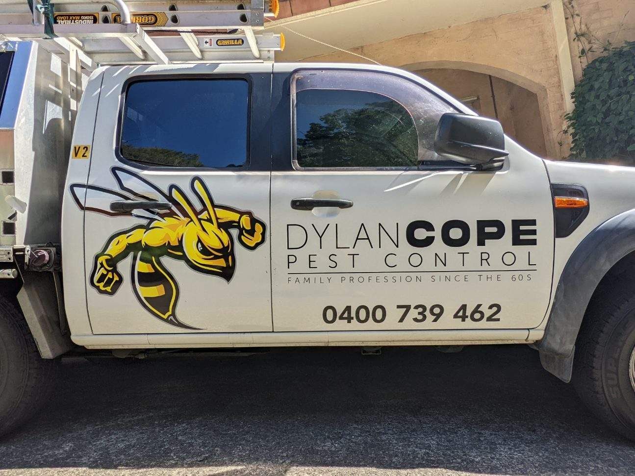 A White Truck with A Bee on The Side of It — Illawarra Sign Group in Bulli, NSW