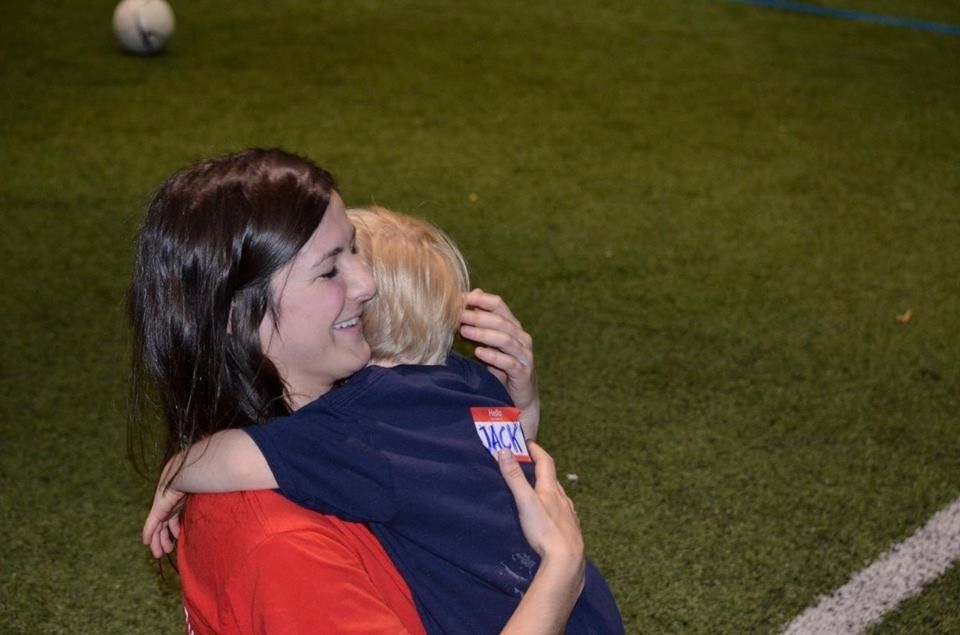 Photo of a Buddy volunteer hugging a participant